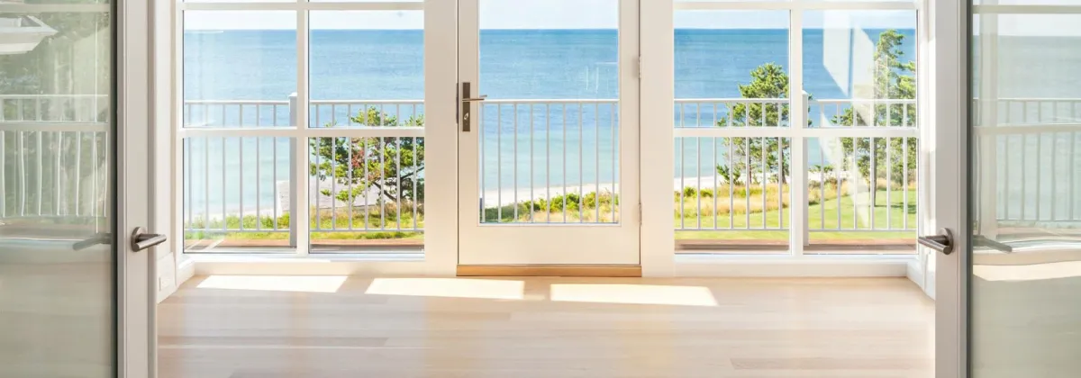 Bright room with white windows and glass doors