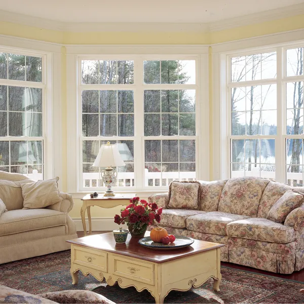 Living room with a wall of white-framed windows
